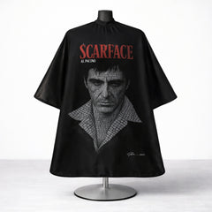 Professional Scarface barber cape used for haircuts and grooming in barbershops.